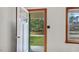 View of the entry and surrounding outdoor landscape visible through a window, natural light at 3899 Warrenton Rd, Henderson, NC 27537