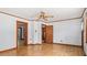 Spacious living room featuring hardwood floors, ceiling fan, and multiple doorways at 3899 Warrenton Rd, Henderson, NC 27537