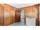 Wood-paneled room with connecting access to the kitchen and tile flooring at 3899 Warrenton Rd, Henderson, NC 27537