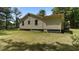 Exterior showcasing the yard and landscaping, combining comfort and natural beauty at 3899 Warrenton Rd, Henderson, NC 27537