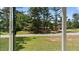View from inside showing the yard and greenery outside, offering a glimpse of outdoor living at 3899 Warrenton Rd, Henderson, NC 27537