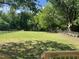 Expansive and well-maintained backyard, surrounded by mature trees and fencing at 409 S Flanner St St, Burlington, NC 27215