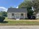 Charming single-story home with covered front porch and freshly manicured lawn at 409 S Flanner St St, Burlington, NC 27215