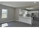 Bright open kitchen design with white cabinets, island, and stainless-steel appliances at 409 S Flanner St St, Burlington, NC 27215