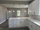 Modern kitchen featuring white cabinets, granite countertops, and pendant lighting at 409 S Flanner St St, Burlington, NC 27215