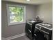 Laundry room with modern washer and dryer, plus natural light from the window at 409 S Flanner St St, Burlington, NC 27215