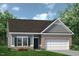 Charming one-story home featuring a brick facade, attached garage, and manicured lawn at 48 Spirit Springs Rd, Smithfield, NC 27577