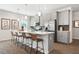Bright kitchen features stainless appliances, grey cabinets and a spacious island with barstool seating at 48 Spirit Springs Rd, Smithfield, NC 27577