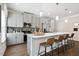 Bright kitchen features stainless appliances, grey cabinets and a spacious island with barstool seating at 48 Spirit Springs Rd, Smithfield, NC 27577