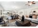 Open-concept living room with modern decor, hardwood floors, and a seamless flow to the kitchen and dining area at 48 Spirit Springs Rd, Smithfield, NC 27577