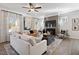 Living room features a ceiling fan, fireplace, and large windows that provide plenty of natural light at 48 Spirit Springs Rd, Smithfield, NC 27577