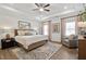 Spacious main bedroom with tray ceiling, plush carpeting, and natural light from large windows at 48 Spirit Springs Rd, Smithfield, NC 27577