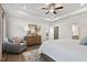 Bright main bedroom with tray ceiling, hardwood floors, and an open doorway into an en-suite bathroom at 48 Spirit Springs Rd, Smithfield, NC 27577