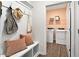 Well-organized mudroom with bench, hooks, and access to the laundry room with washer and dryer at 48 Spirit Springs Rd, Smithfield, NC 27577