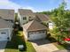 Aerial view of the home and garage with a long driveway at 49 Salt Cedar Ln, Chapel Hill, NC 27516