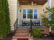 Back porch with chairs and brick steps at 49 Salt Cedar Ln, Chapel Hill, NC 27516