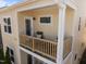 Balcony with light yellow siding, a wood railing and a comfy place to relax at 49 Salt Cedar Ln, Chapel Hill, NC 27516