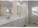 Bathroom boasts dual sinks, framed mirrors and white cabinets for storage at 49 Salt Cedar Ln, Chapel Hill, NC 27516