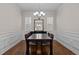 Traditional dining room features a dark wood table, a mirror, and chair rail molding at 49 Salt Cedar Ln, Chapel Hill, NC 27516