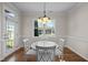 Bright dining area features a white table and chairs with a light fixture above at 49 Salt Cedar Ln, Chapel Hill, NC 27516