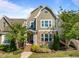Charming home with a stone facade, complemented by manicured landscaping and a welcoming entrance at 49 Salt Cedar Ln, Chapel Hill, NC 27516