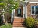Inviting front entrance with brick steps, iron railings, and a covered porch, creating a warm welcome at 49 Salt Cedar Ln, Chapel Hill, NC 27516
