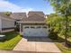 Attached two-car garage featuring a carriage door, clean concrete driveway, and tasteful landscaping at 49 Salt Cedar Ln, Chapel Hill, NC 27516