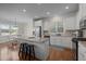 Bright kitchen features granite countertops, stainless steel appliances, and a central island with barstool seating at 49 Salt Cedar Ln, Chapel Hill, NC 27516