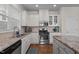 Bright kitchen features stainless steel appliances, granite countertops, tiled backsplash, an island, and hardwood flooring at 49 Salt Cedar Ln, Chapel Hill, NC 27516