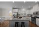 Bright kitchen features granite countertops, stainless steel appliances, and a central island with barstool seating at 49 Salt Cedar Ln, Chapel Hill, NC 27516