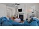 Comfortable living room featuring a fireplace, ceiling fan, and ample natural light, perfect for gatherings at 49 Salt Cedar Ln, Chapel Hill, NC 27516