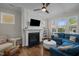Cozy living room with fireplace, large windows, and comfortable seating, ideal for relaxation at 49 Salt Cedar Ln, Chapel Hill, NC 27516
