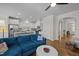 Spacious living area with hardwood floors, a comfortable sectional, and an open view to the modern kitchen at 49 Salt Cedar Ln, Chapel Hill, NC 27516