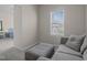 Sitting room with a gray sofa and a window letting in natural light at 49 Salt Cedar Ln, Chapel Hill, NC 27516