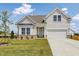 Charming two-story home features a well-maintained lawn and an attached two-car garage at 504 Winding Creek Dr Dr, Lillington, NC 27546