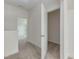 Hallway with neutral carpet leads to additional rooms and a walk-in closet with white painted trim at 504 Winding Creek Dr Dr, Lillington, NC 27546