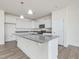 Open kitchen features a large island, white cabinets, granite countertops, and modern lighting at 504 Winding Creek Dr Dr, Lillington, NC 27546