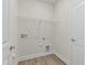 Convenient laundry room with wood-look floors and utility connections at 504 Winding Creek Dr Dr, Lillington, NC 27546