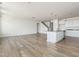 Open-concept living room with modern flooring flows into a spacious kitchen and staircase at 504 Winding Creek Dr Dr, Lillington, NC 27546