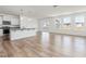Bright living room with wood-look floors is connected to an open kitchen with lots of light at 504 Winding Creek Dr Dr, Lillington, NC 27546