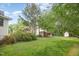 Lush backyard with mature trees and lawn; perfect for relaxing or entertaining at 515 Poplar Dr, Raleigh, NC 27603