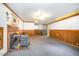 Basement area featuring wood burning stove, wood paneling, and plush carpet at 515 Poplar Dr, Raleigh, NC 27603