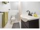 Compact bathroom with a corner sink, toilet, and shower stall, ideal for guests at 515 Poplar Dr, Raleigh, NC 27603