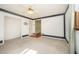 Spacious carpeted bedroom with a ceiling fan, natural light, and attached closet at 515 Poplar Dr, Raleigh, NC 27603