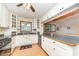 Bright kitchen with white cabinets, stainless steel appliances, and a view into the dining area at 515 Poplar Dr, Raleigh, NC 27603