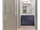 Modern bathroom with navy vanity, white countertop, framed mirror, and neutral flooring at 522 Lochness Ln, Cary, NC 27511