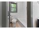 Bathroom featuring a white toilet, bathtub with textured subway tile, and a window at 522 Lochness Ln, Cary, NC 27511