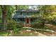 Charming two-story home with a welcoming porch and vibrant red front door surrounded by lush landscaping at 522 Lochness Ln, Cary, NC 27511