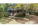 Traditional home with a red door, covered porch, and mature tree providing shade and curb appeal at 522 Lochness Ln, Cary, NC 27511