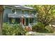 Classic home with a covered porch, brick steps, a striking red door, and well-maintained landscaping at 522 Lochness Ln, Cary, NC 27511